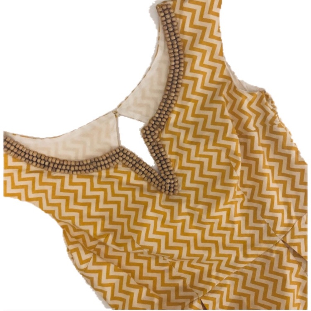 Peplum top w/ mustard-colored chevron and beading